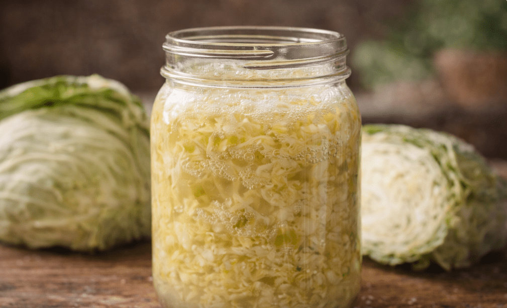 Active sauerkraut fermentation with bubbles and cloudy brine. This is normal.